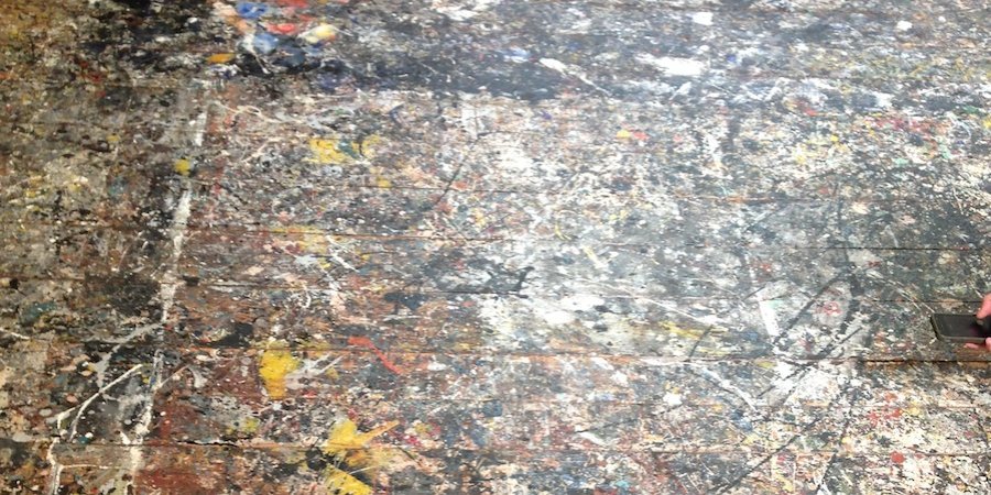It is possible to see the outlines of the canvases the artist taped to the floor before covering them with his celebrated "all-over" compositions.