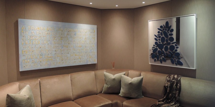 A joke painting by Richard Prince and a more recent piece by the artist are displayed together in this sitting room.