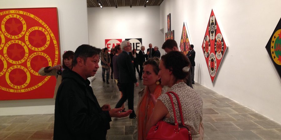 Art journalists Paul Laster, Katya Kazakina, and a friend talking at the opening