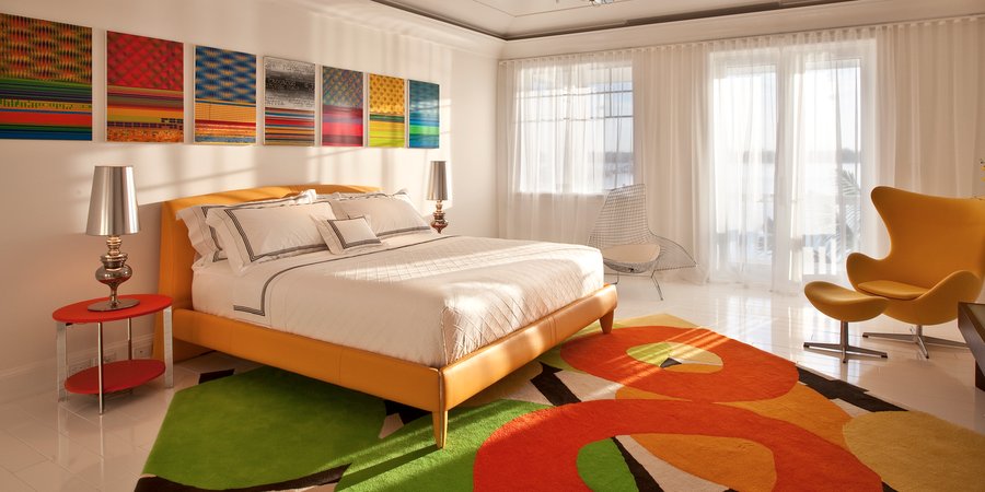 Beverly Fishman works hang above the bed in Wasserman's Florida home, with a rug by Marcus Weggenmann