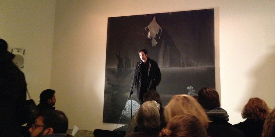 The painter and poet Stefan Bondell MCing a poetry reading he held amidst his show of new paintings at the Hole gallery.