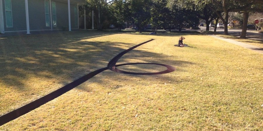A Michael Heizer earthwork confronts visitors outside the Menil