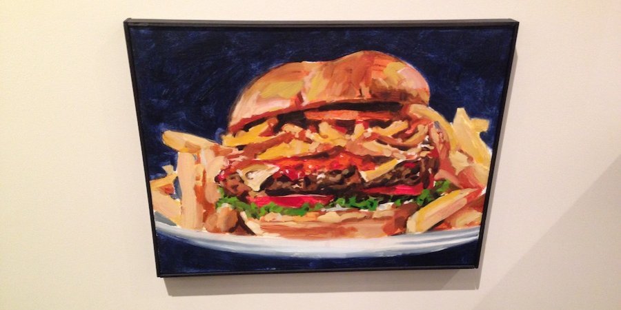 One of Walter Robinson's mouthwatering hamburger paintings in the Metro Pictures show