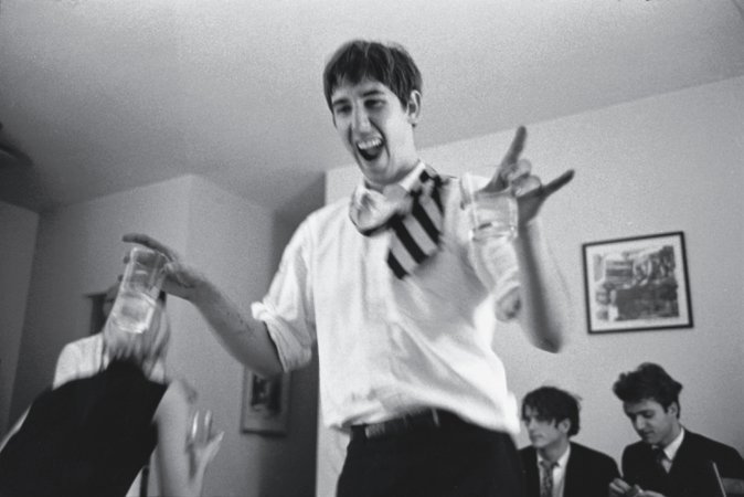 Edmund Hennessy, one of the Cambridge crowd, in Dorothy Deanâ€™s apartment; Gerard Malanga in background next to unidentified man