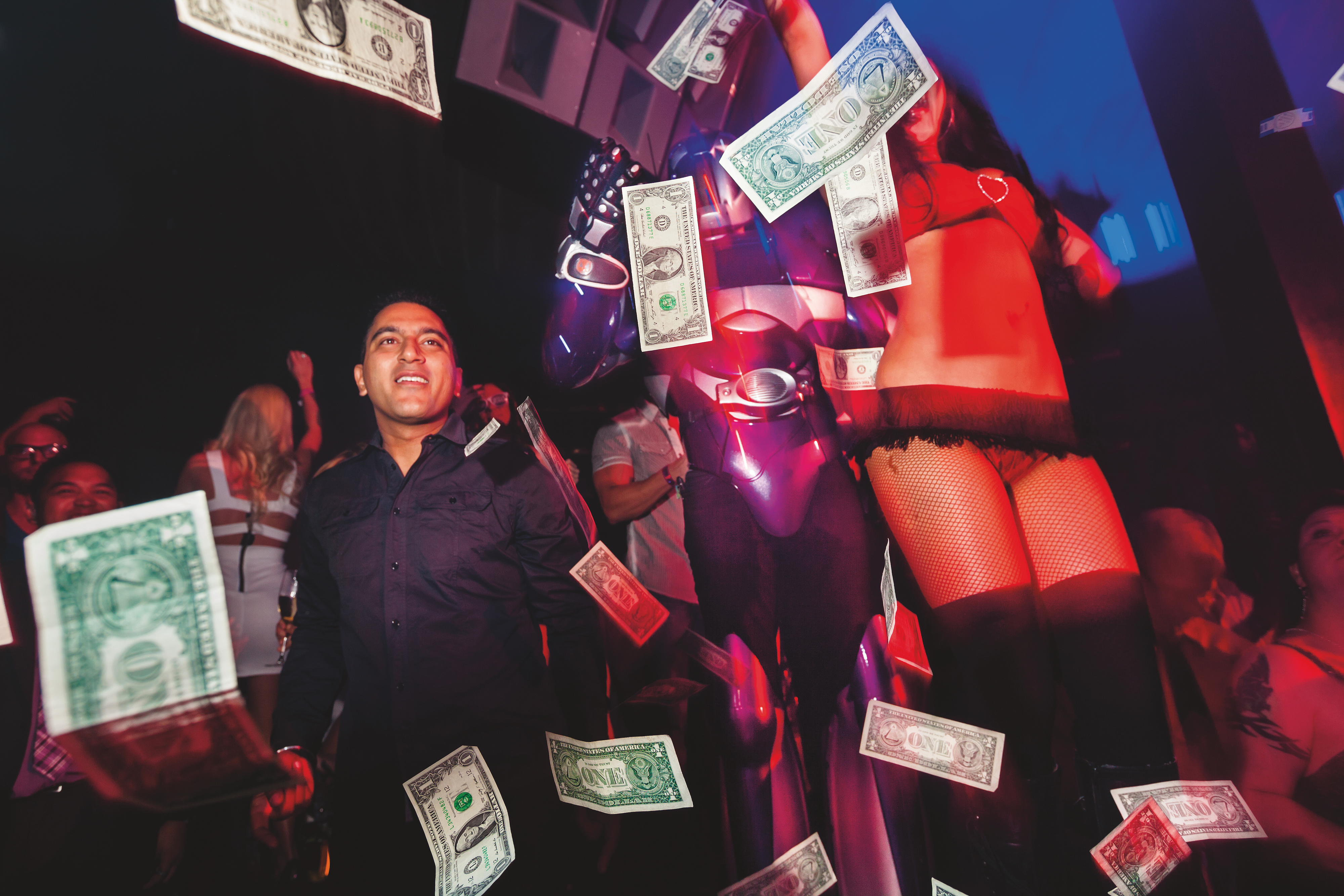 A VIP guest “makes it rain” with hundreds of dollar bills on a sold-out Saturday night at 
