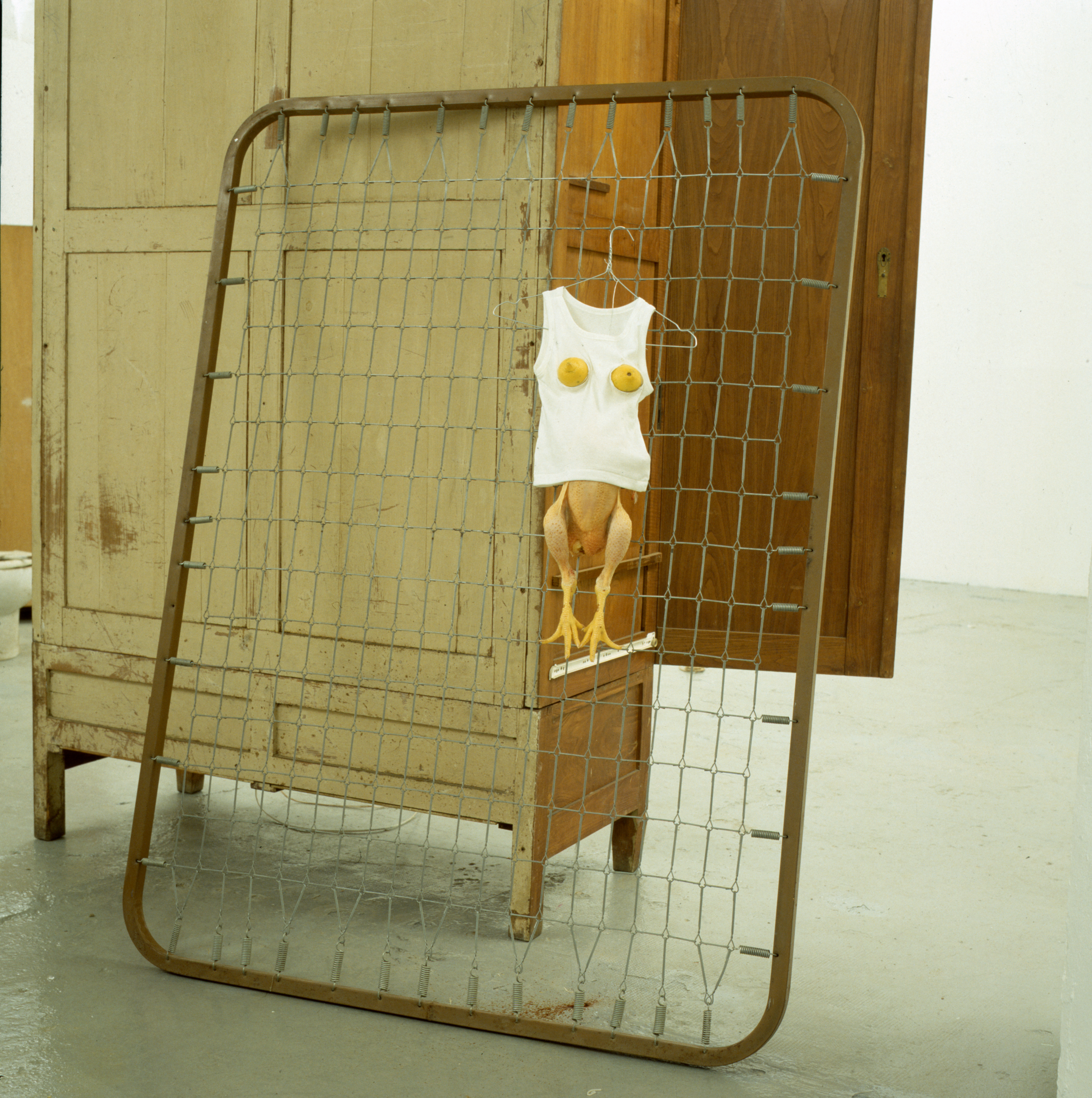Sarah Lucas, Sex Baby Bed Base, 2000. Bed case, chicken, T-shirt, lemons, and hanger, 70 7