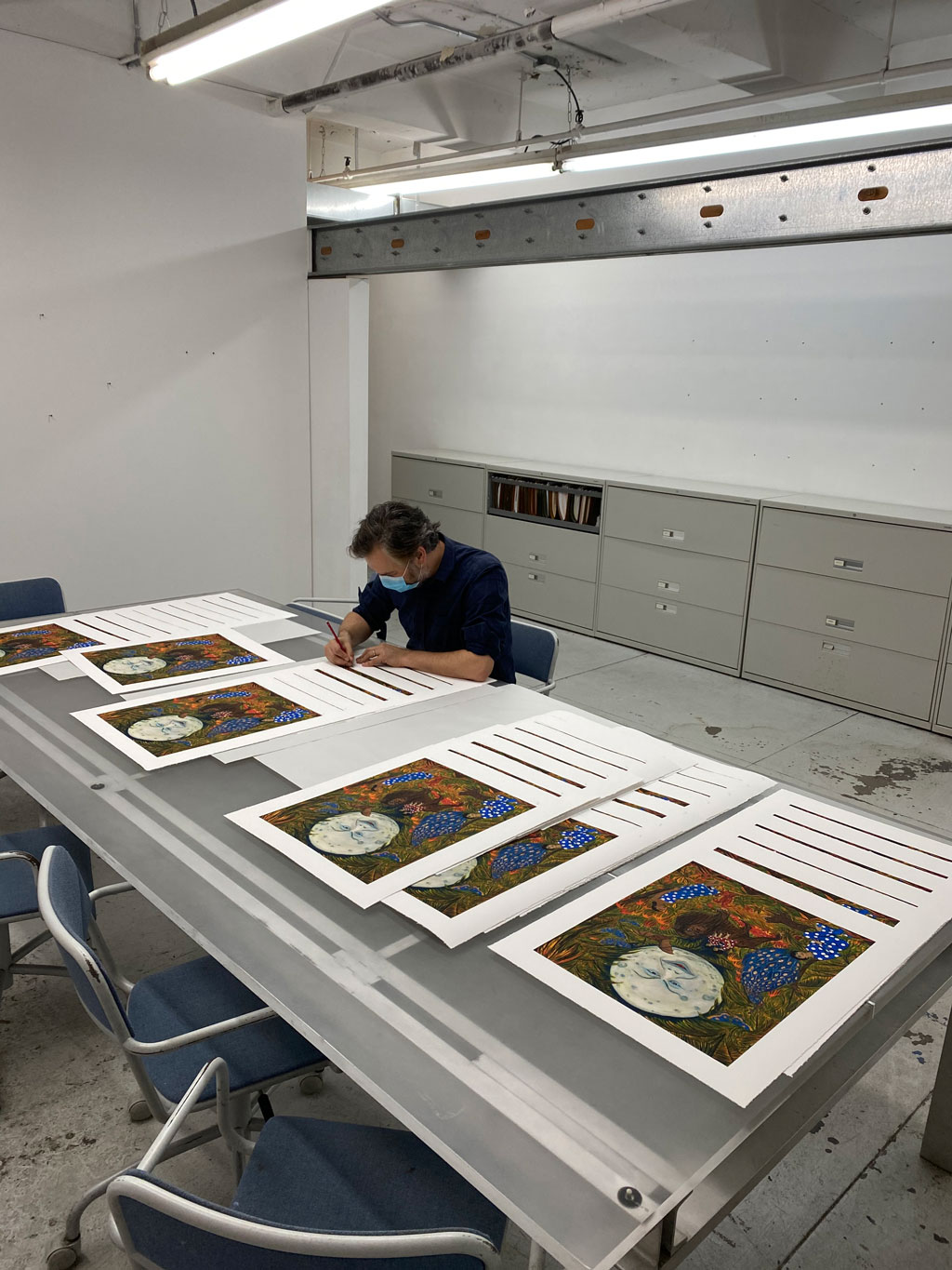 Marcel Dzama signing his Artspace/ RxART limited edition The Illumination of the sisters o
