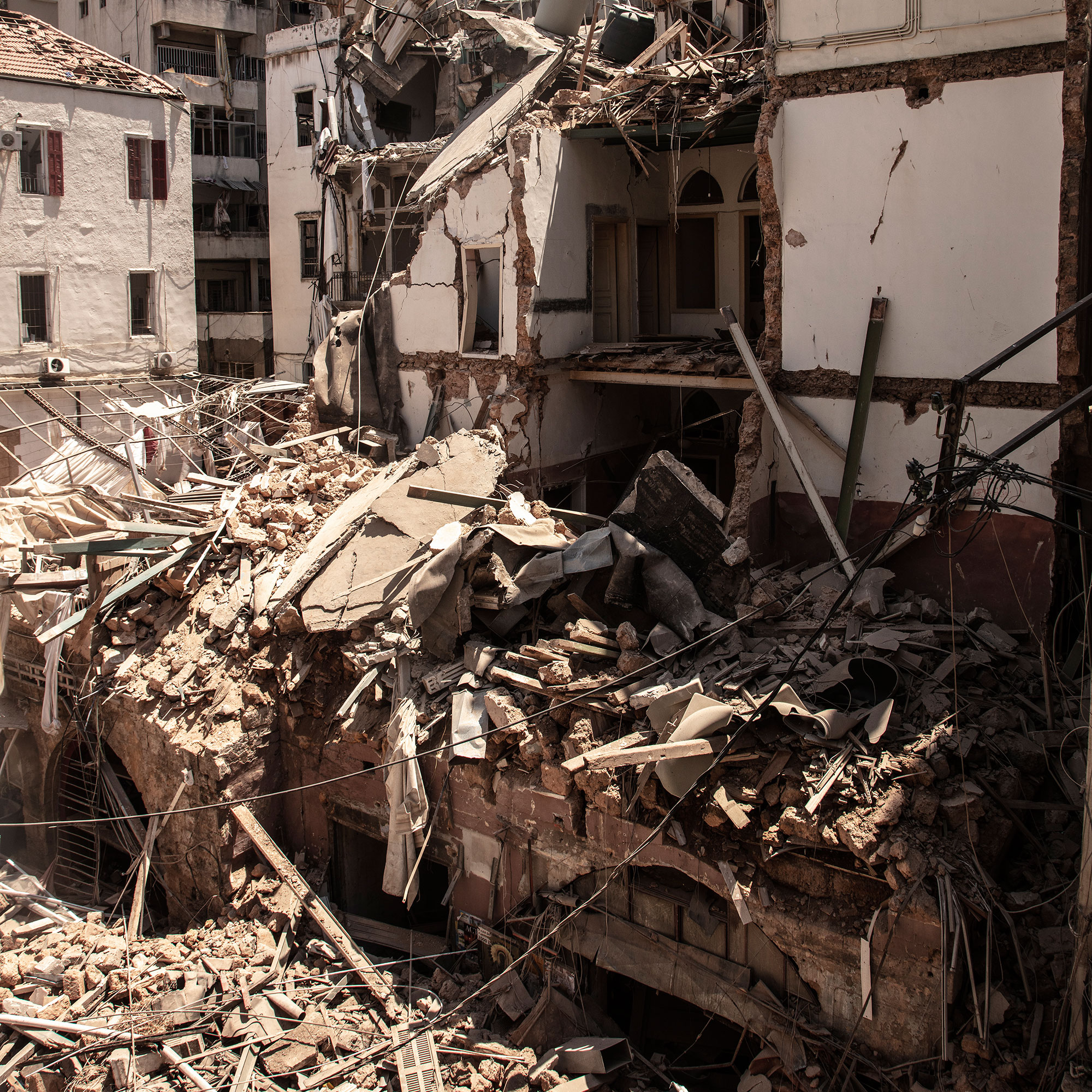 Collapsed buildings in the streets next to Moukaddem's apartment