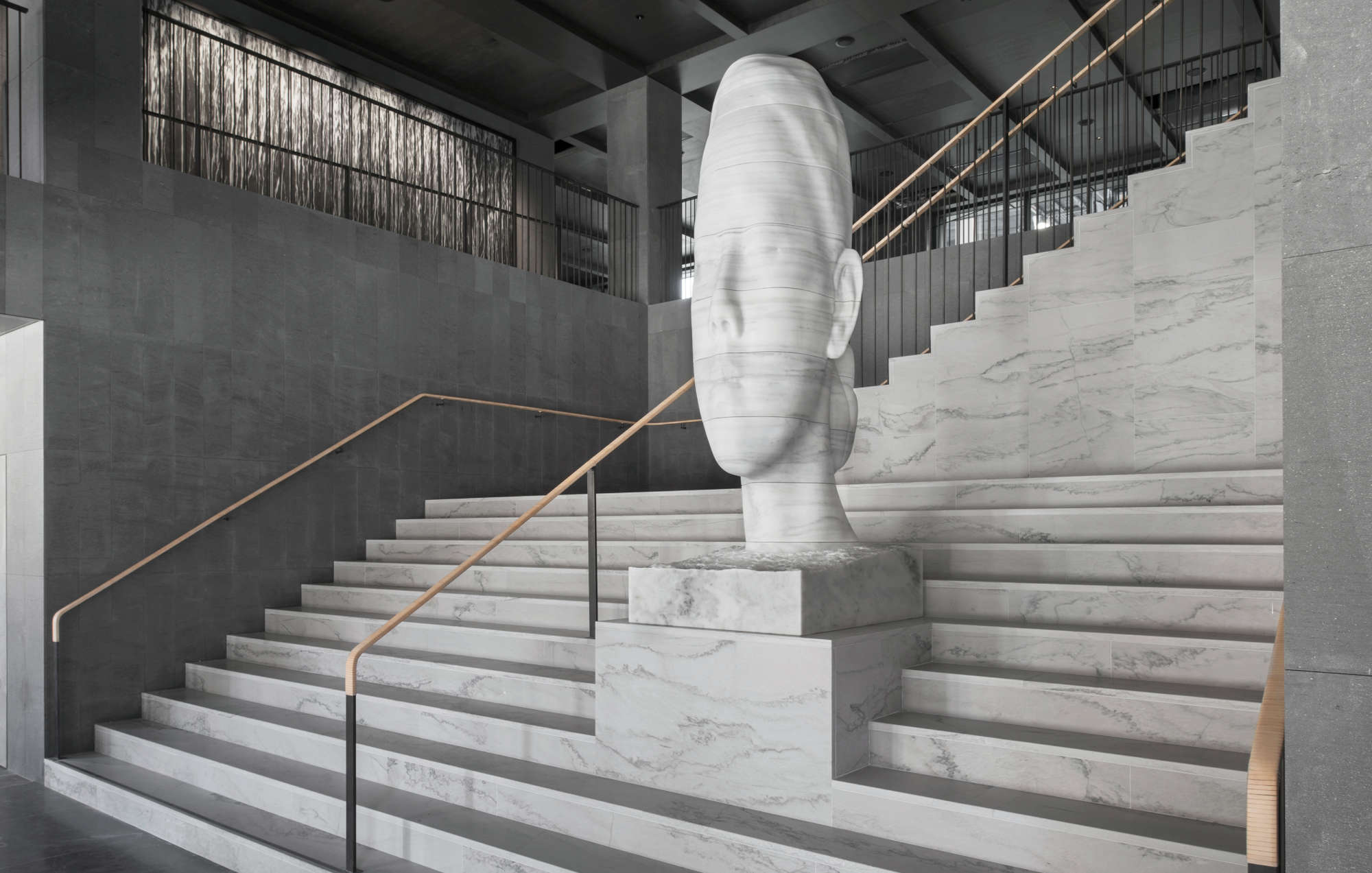 Mar Whispering (2017) by Jaume Plensa on the grand stair in the hotel lobby