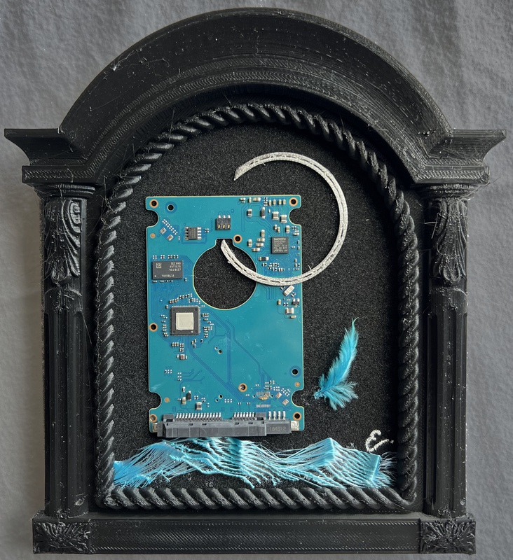 picture of the exhibition location Perpetual Benediction Mixed Media including black foam, motherboard, polylactic acid (PLA), feather, acrylic 8.5" x 8" x.75" 2023 retail price $420