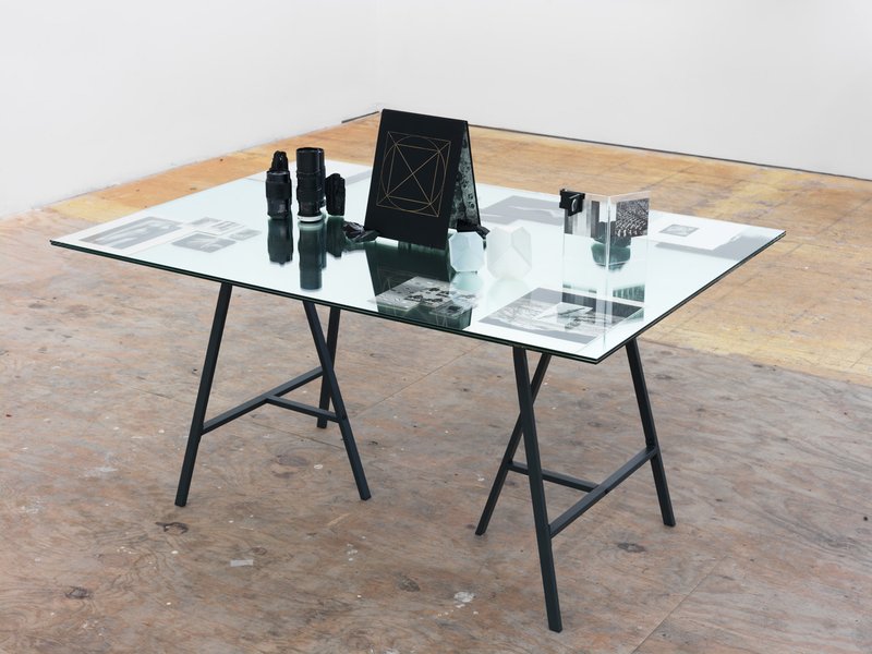 picture of the exhibition location Untitled (Everything that is dead quivers), 2016 book pages, book covers, clippings, camera lenses and tourmaline and obsidian rocks 39 x 55 inches (99.06 x 139.70 cm) Dimensions variable
