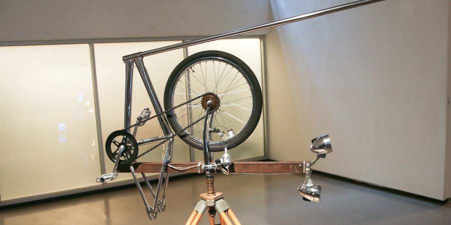 Navarro's own piece, 'Satellite,' utlizes bicycle parts, a human-powered electric generator, and electric energy to make comment on the show's premise.