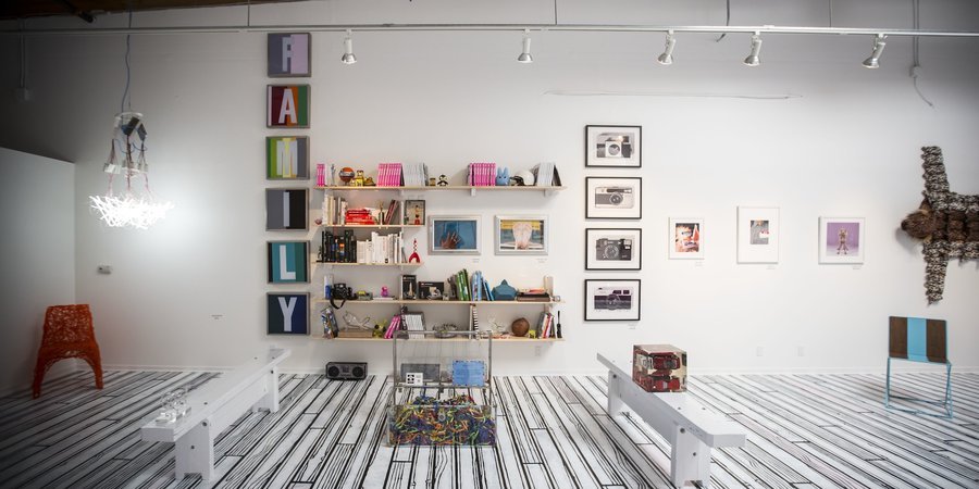 Works by William Wegman and Paul Ramirez Jonas appear alongside a curated collection of art books.