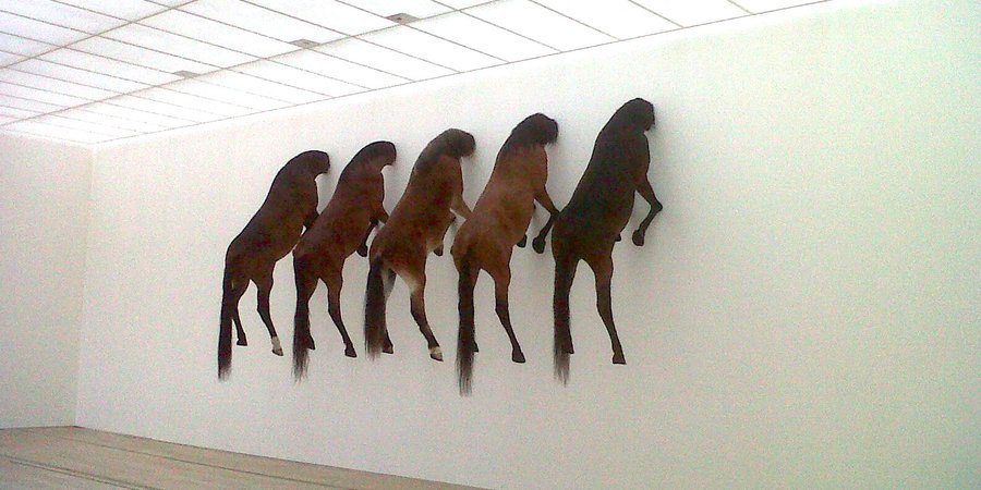 Maurizio Cattelan's taxidermied horses on view in his solo show "Kapput" at the Beyeler Fondation in Basel