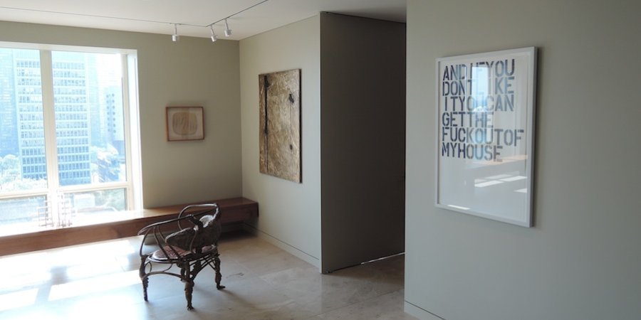From right, a small Sol LeWitt sculpture by the window echoing the Chicago skyscrapers visible outside, a Lucio Fontana piece of a tablet of slashed and fired clay, a Rashid Johnson bronze encrusted by black soap, and a Christopher Wool; on the floor is a crocodile chair by Claude and François-Xavier Lalanne