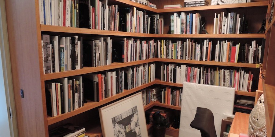 An art library sits at the divide between the living quarters and the gallery.