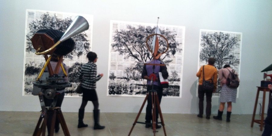Works on paper made with India ink are surrounded by readymade, megaphone sculptures.