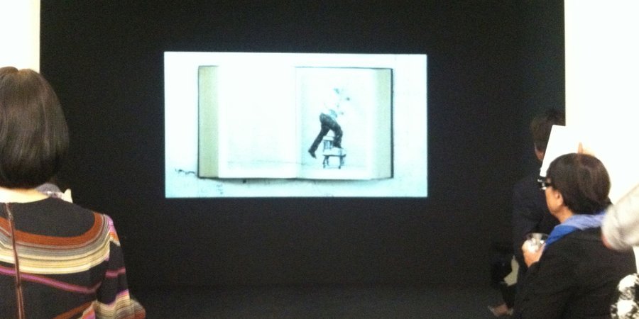 The film "Second-hand Reading," 2013 plays in the back of the gallery.