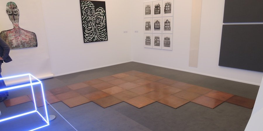 Carl Andre's <em>Cyprigene Sum</em> (1994), consisting of 36 copper plates arranged in a triangle, at Konrad Fischer Galerie