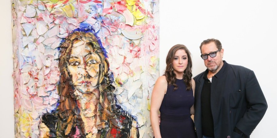 Allison Brant (daughter of Peter) and Julian Schnabel pose by the artist's plate portrait of her at the Brant Foundation