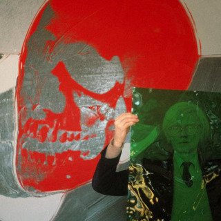 Thomas Hoepker, New York City. 1981. Andy Warhol with a skull painting in his "Factory" at Union Square.
